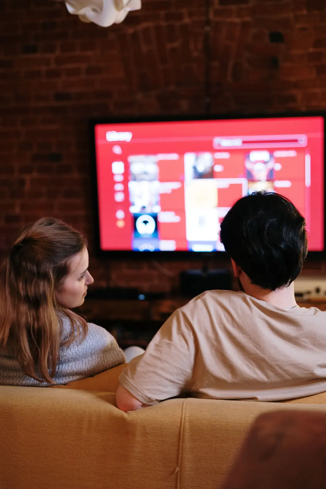Couple watching a movie on a smart TV in their living room